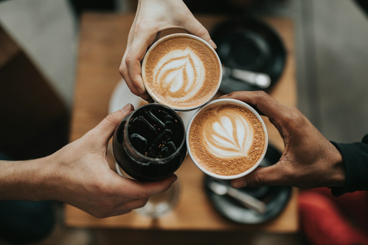 Warm coffee cups on a wooden table at golden hour